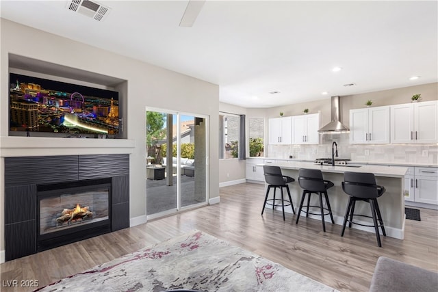 191 Reed Ln, Henderson, NV 89074 - living room with light wood-type flooring, recessed lighting, baseboards, and a glass covered fireplace