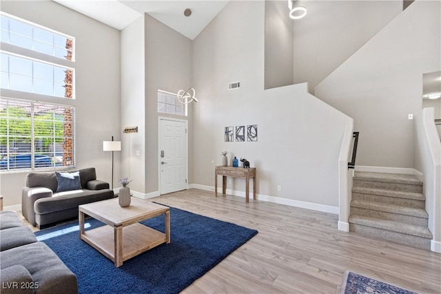 191 Reed Ln, Henderson, NV 89074 - living room with a towering ceiling, wood finished floors, stairway, and baseboards