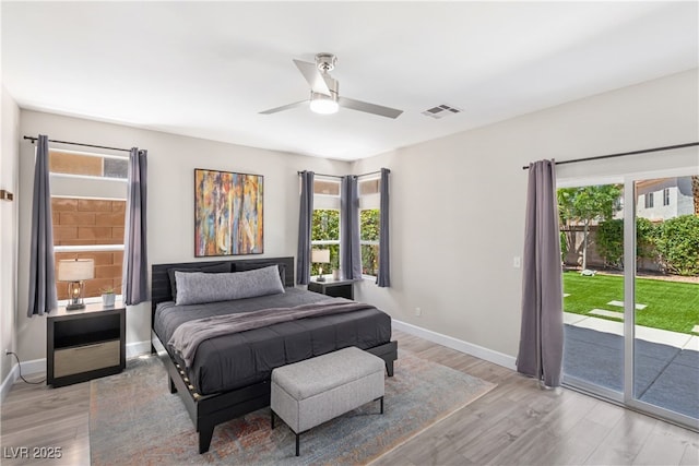 191 Reed Ln, Henderson, NV 89074 - bedroom with access to outside, multiple windows, and light wood-type flooring