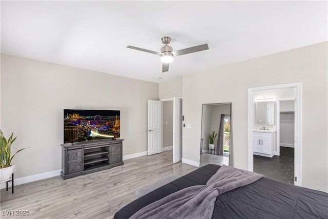 191 Reed Ln, Henderson, NV 89074 - bedroom with light wood-style floors, baseboards, a ceiling fan, and connected bathroom