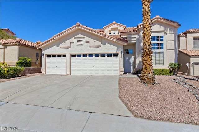 191 Reed Ln, Henderson, NV 89074 - view of front facade with driveway, an attached garage, a tile roof, and stucco siding