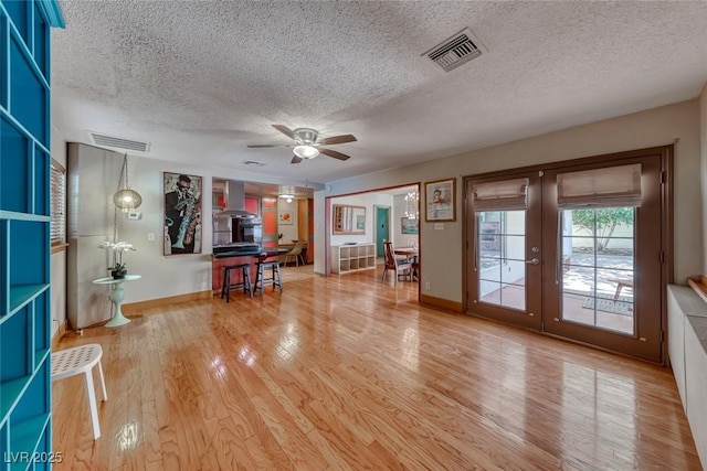 1721 E Oakey Blvd, Las Vegas, NV 89104 - unfurnished living room featuring a textured ceiling, a ceiling fan, french doors, wood finished floors, and baseboards
