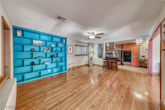 1721 E Oakey Blvd, Las Vegas, NV 89104 - office space with light wood finished floors, ceiling fan, a textured ceiling, built in features, and baseboards