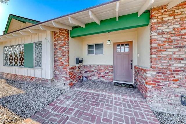 1721 E Oakey Blvd, Las Vegas, NV 89104 - doorway to property with stucco siding and board and batten siding