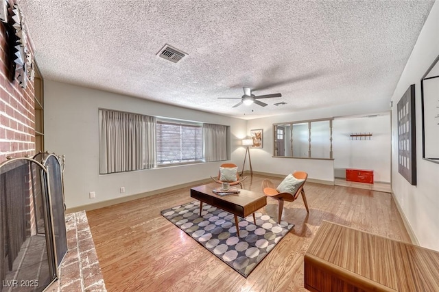 1721 E Oakey Blvd, Las Vegas, NV 89104 - living area with wood finished floors, a ceiling fan, baseboards, and a textured ceiling
