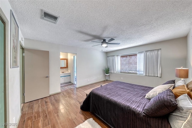 1721 E Oakey Blvd, Las Vegas, NV 89104 - bedroom featuring wood finished floors, a textured ceiling, ceiling fan, and ensuite bath