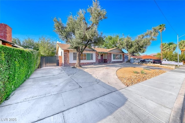 1721 E Oakey Blvd, Las Vegas, NV 89104 - ranch-style home with concrete driveway, brick siding, a gate, and fence