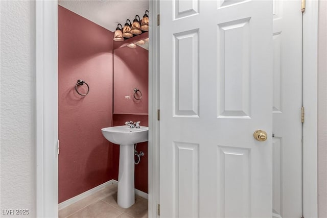 bathroom with tile patterned flooring and baseboards