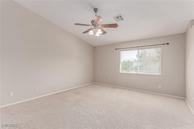 spare room featuring baseboards, carpet, vaulted ceiling, and a ceiling fan
