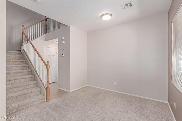 stairs featuring carpet flooring and baseboards