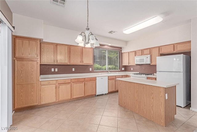 kitchen featuring white appliances, a chandelier, a sink, light countertops, and light brown cabinetry