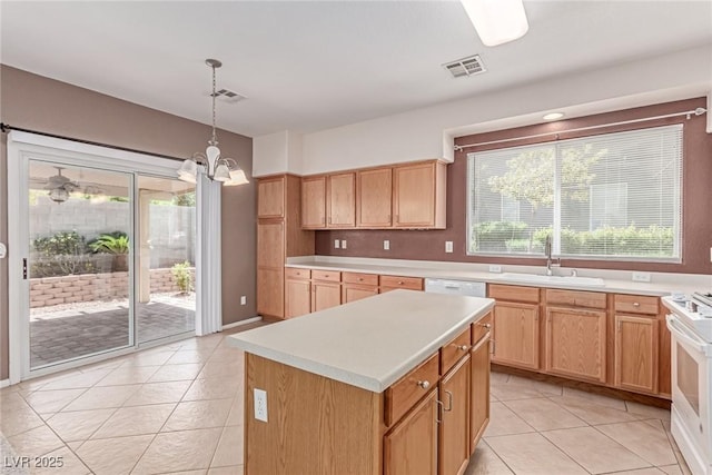 kitchen with a sink, light tile patterned floors, light countertops, a chandelier, and white appliances