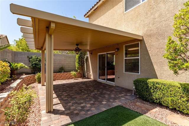view of patio / terrace featuring ceiling fan and fence