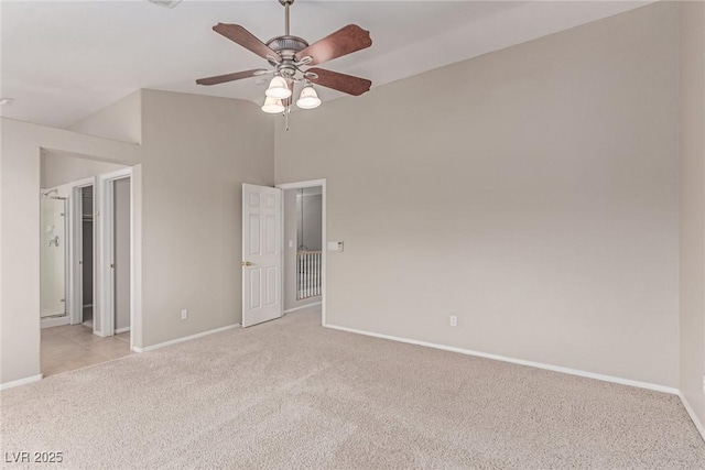 unfurnished bedroom featuring light carpet, baseboards, and a ceiling fan