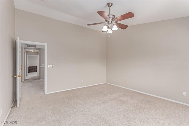 unfurnished room featuring light carpet, a ceiling fan, and baseboards