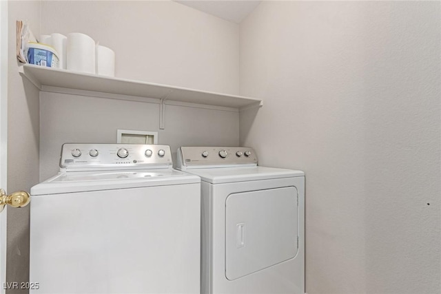 clothes washing area featuring washer and clothes dryer