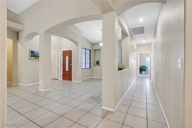 2309 Tedesca Dr, Henderson, NV 89052 - hall with light tile patterned flooring, arched walkways, and baseboards