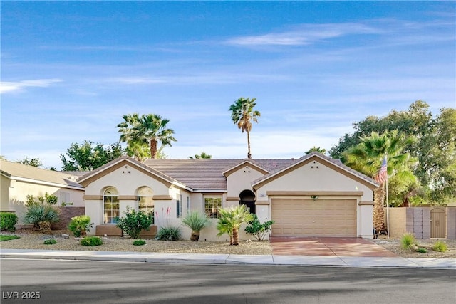 2309 Tedesca Dr, Henderson, NV 89052 - view of front of home featuring stucco siding, driveway, an attached garage, a tiled roof, and a gate