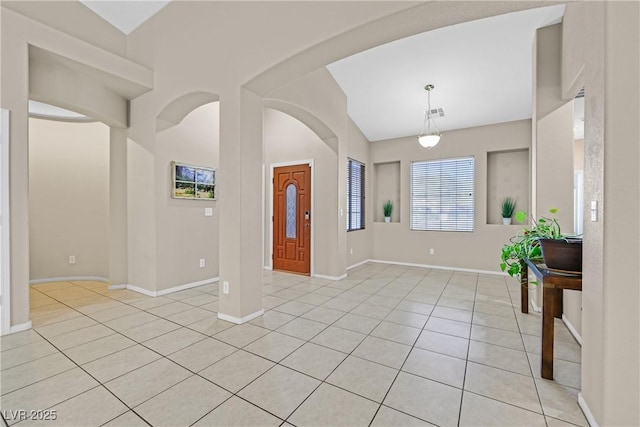 2309 Tedesca Dr, Henderson, NV 89052 - foyer entrance with vaulted ceiling, light tile patterned floors, baseboards, and arched walkways