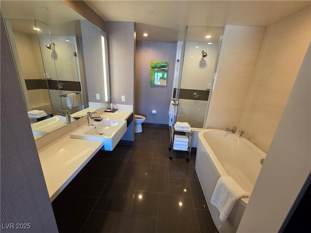 full bathroom with toilet, a shower stall, tile patterned flooring, a garden tub, and vanity