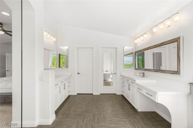 2940 Cimini Ct, Henderson, NV 89052 - ensuite bathroom with two vanities, vaulted ceiling, and ceiling fan