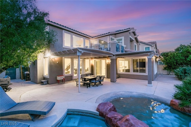 2940 Cimini Ct, Henderson, NV 89052 - back of property featuring a balcony, stucco siding, a tiled roof, and fence