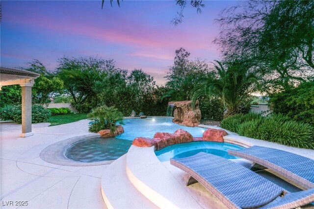 2940 Cimini Ct, Henderson, NV 89052 - pool at dusk featuring a pool with connected hot tub and a patio