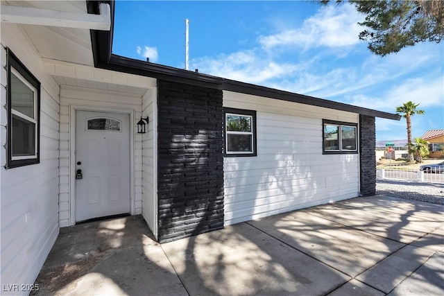 4186 Toronto Cir, Las Vegas, NV 89121 - doorway to property featuring a patio area and stone siding