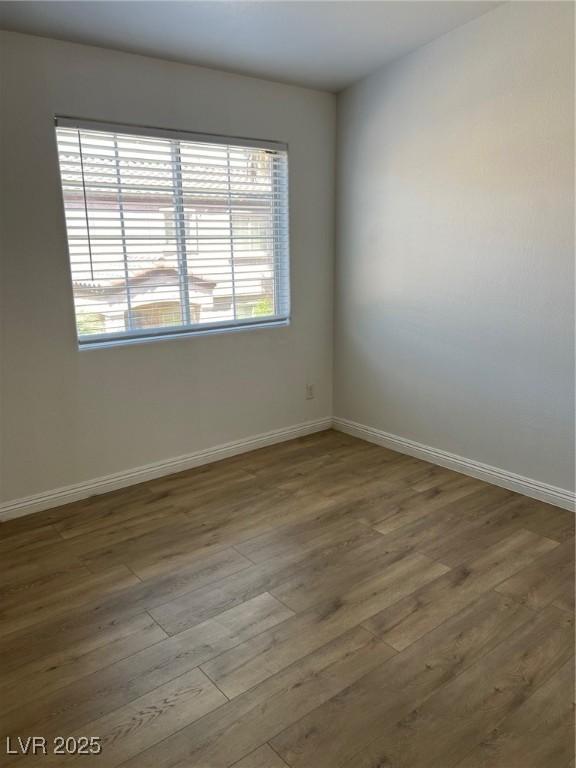unfurnished room featuring wood finished floors and baseboards
