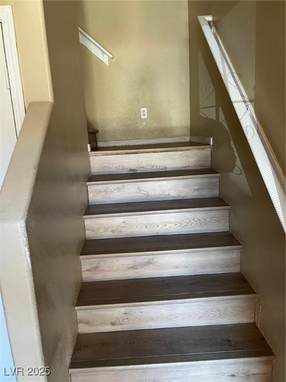 stairs featuring hardwood / wood-style floors