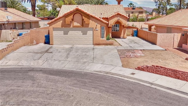 5536 Cleary Ct, Las Vegas, NV 89108 - view of front of house featuring a tiled roof, driveway, fence, a gate, and an attached garage