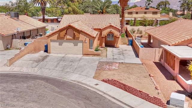 5536 Cleary Ct, Las Vegas, NV 89108 - view of front of home with a tile roof, driveway, central AC unit, fence, and a garage