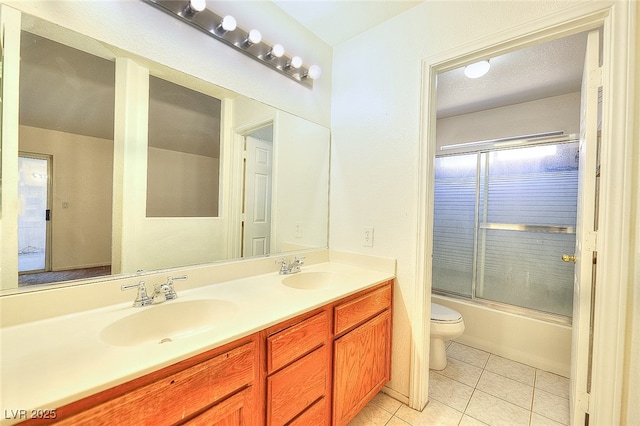 5536 Cleary Ct, Las Vegas, NV 89108 - full bathroom with tile patterned floors, toilet, double vanity, and enclosed tub / shower combo