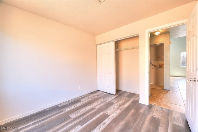 5536 Cleary Ct, Las Vegas, NV 89108 - unfurnished bedroom featuring dark wood-type flooring, a closet, and baseboards