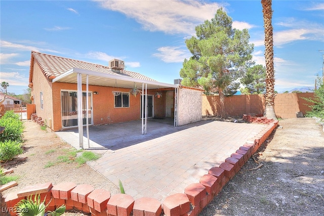 5536 Cleary Ct, Las Vegas, NV 89108 - back of property featuring a fenced backyard, a patio area, stucco siding, central AC unit, and a tiled roof