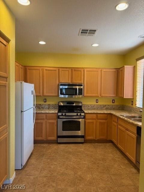 8325 Aspen Village St, Las Vegas, NV 89113 - kitchen with appliances with stainless steel finishes, recessed lighting, and light tile patterned floors