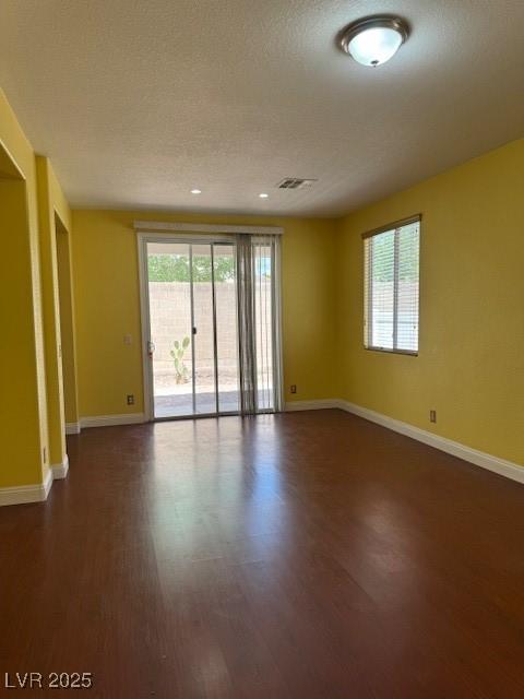 8325 Aspen Village St, Las Vegas, NV 89113 - spare room featuring dark wood-type flooring and healthy amount of natural light