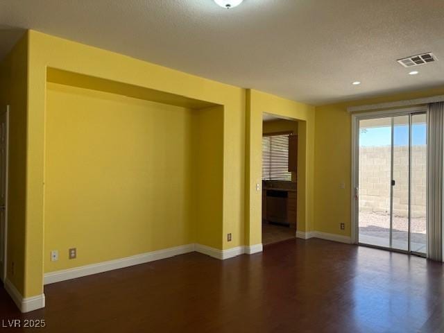 8325 Aspen Village St, Las Vegas, NV 89113 - spare room featuring dark wood-style floors and a textured ceiling