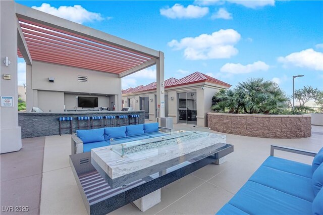 200 W Sahara Ave Unit 603, Las Vegas, NV 89102 - view of patio / terrace with an outdoor living space with a fire pit, an outdoor kitchen, and a bar