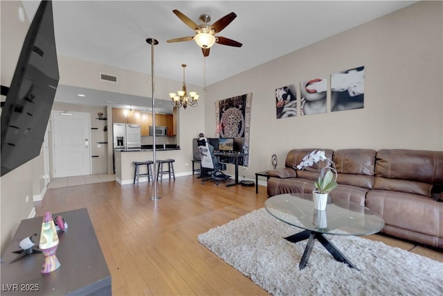 200 W Sahara Ave Unit 603, Las Vegas, NV 89102 - living room with a ceiling fan, light wood-style floors, a chandelier, and baseboards