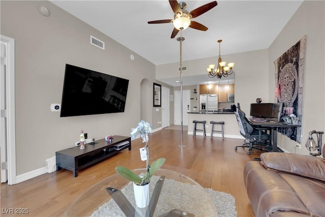 200 W Sahara Ave Unit 603, Las Vegas, NV 89102 - living room featuring a ceiling fan, a chandelier, light wood-style flooring, baseboards, and an office area
