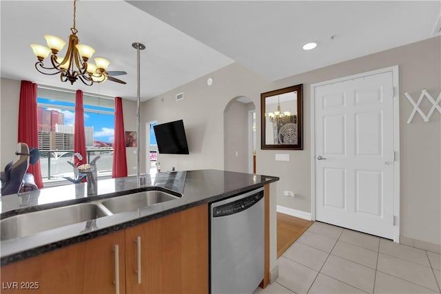 200 W Sahara Ave Unit 603, Las Vegas, NV 89102 - kitchen featuring stainless steel dishwasher, a chandelier, arched walkways, and brown cabinets