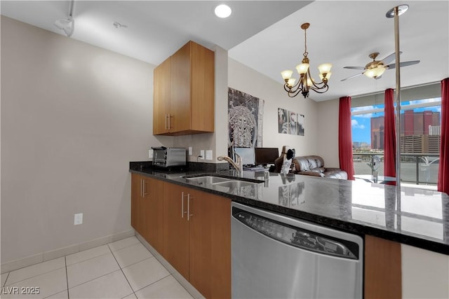200 W Sahara Ave Unit 603, Las Vegas, NV 89102 - kitchen with dishwasher, a sink, open floor plan, a ceiling fan, and dark stone counters
