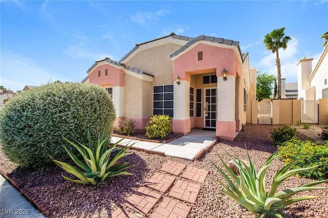 8205 Harrogate Ave, Las Vegas, NV 89129 - view of front of house featuring stucco siding, fence, and a gate