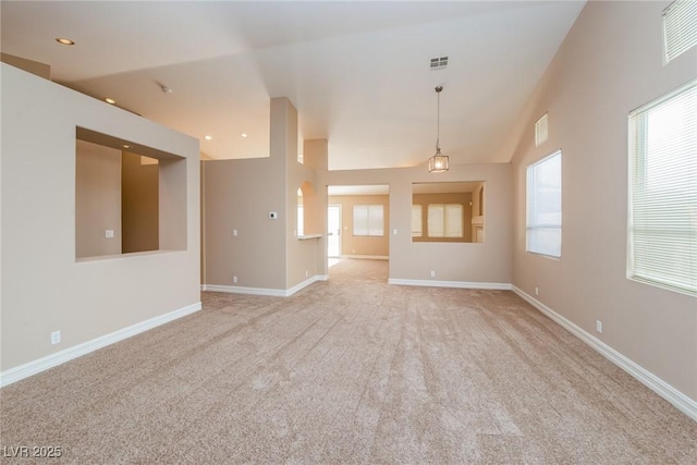 8205 Harrogate Ave, Las Vegas, NV 89129 - unfurnished living room featuring light carpet, baseboards, recessed lighting, and lofted ceiling