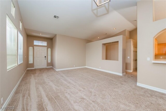 8205 Harrogate Ave, Las Vegas, NV 89129 - unfurnished living room with light carpet, recessed lighting, baseboards, and arched walkways