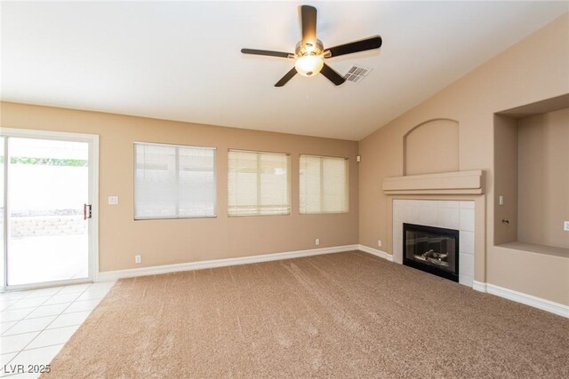 8205 Harrogate Ave, Las Vegas, NV 89129 - unfurnished living room featuring lofted ceiling, ceiling fan, a tile fireplace, light carpet, and baseboards