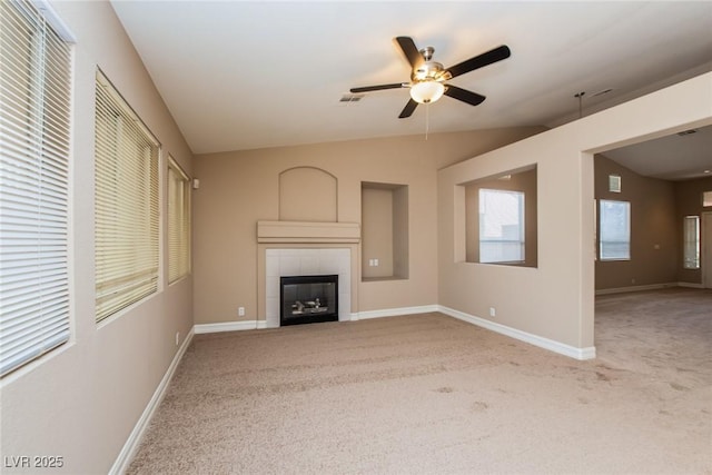 8205 Harrogate Ave, Las Vegas, NV 89129 - unfurnished living room featuring carpet floors, a tile fireplace, ceiling fan, and baseboards