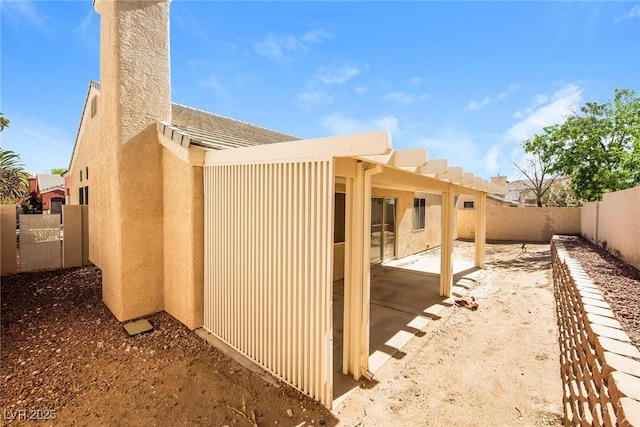 8205 Harrogate Ave, Las Vegas, NV 89129 - view of side of home featuring a fenced backyard, a patio area, and stucco siding
