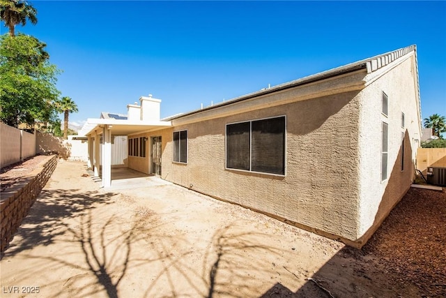8205 Harrogate Ave, Las Vegas, NV 89129 - back of house featuring stucco siding, a fenced backyard, a patio area, and central AC